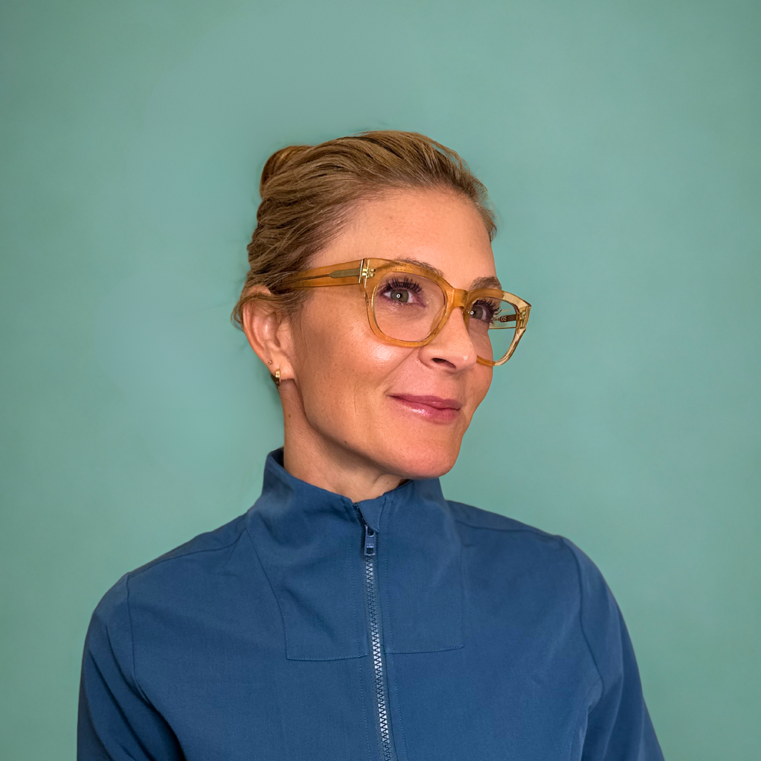 Dr. Krista Archer wearing a blue jacket against a green background