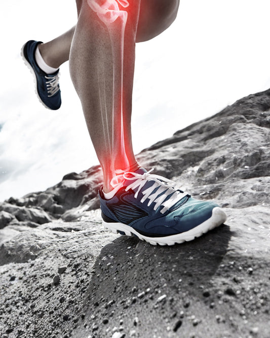 A person's feet shown hiking on rocky terrain. The underlying bones can been seen as though they have been scanned with an X ray