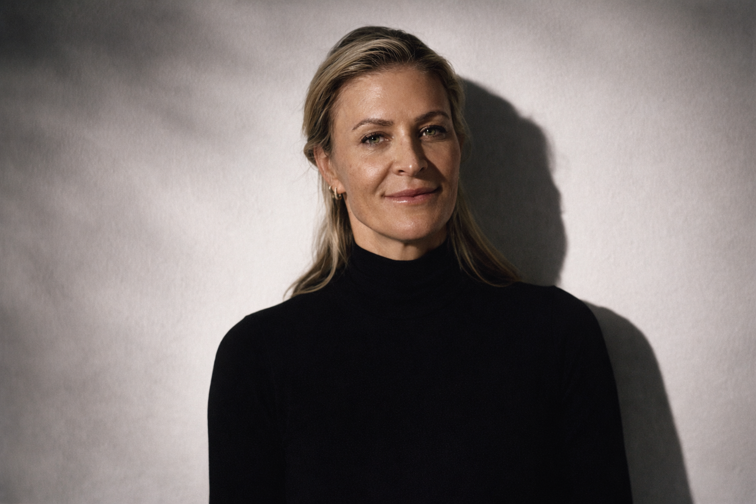 Dr. Krista Archer wearing a black sweater in front of a white background
