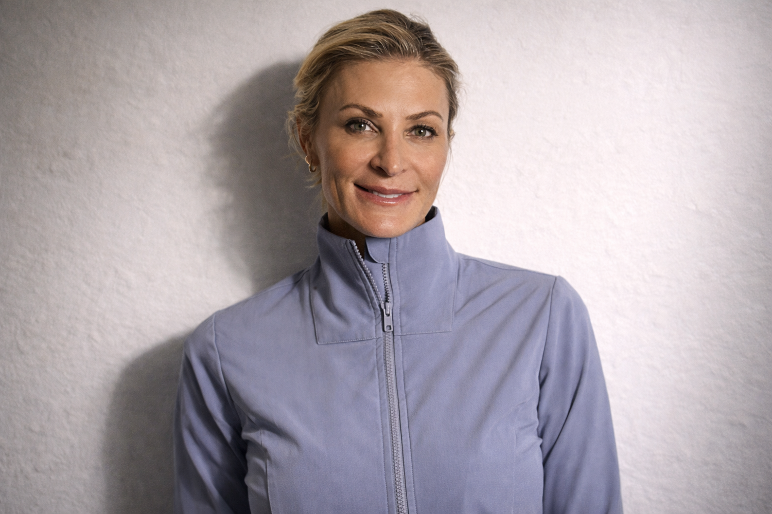 Dr. Krista Archer wearing a light blue jacket against a plain background